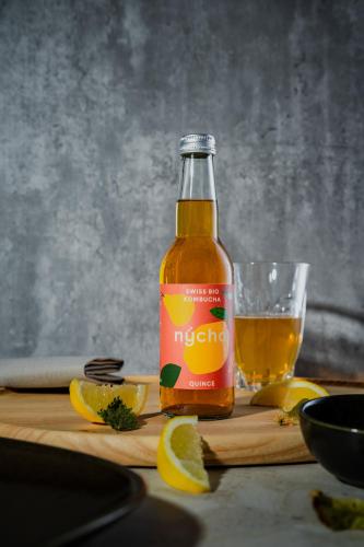 a bottle of orange juice and a glass of juice at Kloster by b-smart in Schaan