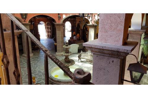 a view of a hallway of a building with a staircase at Hotel Boutique Posada De Las Flores Loreto in Loreto