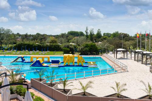 a large swimming pool with slides and rides at a resort at Isola di Albarella Golf Hotel in Isola Albarella