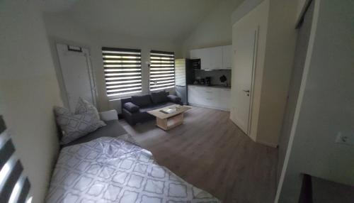 a small living room with a bed and a couch at Ferienwohnung Teichblick in Freiberg
