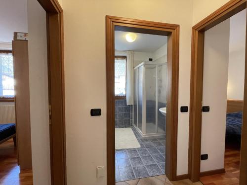 a hallway with a door leading to a bathroom at 081 Trilocale Baldino, Pinzolo in Pinzolo