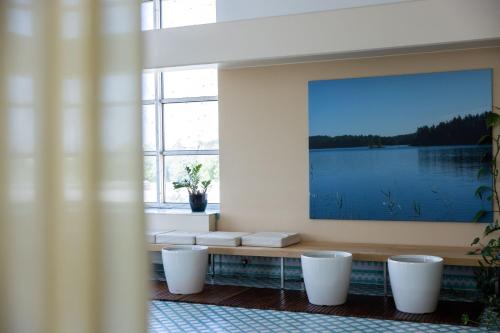 a room with a large painting on the wall at Original Sokos Hotel Vaakuna Mikkeli in Mikkeli