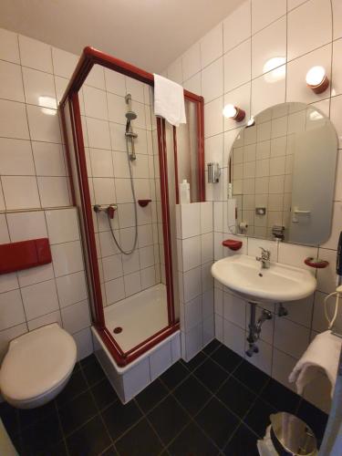 a bathroom with a shower and a sink at Waldschenke Fuhr in Heppenheim an der Bergstrasse