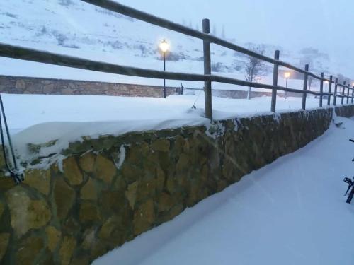 a fence in the snow at night at Casa Majo Valdelinares VUTE-23-002 in Valdelinares