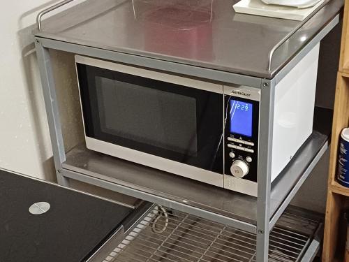 a microwave oven sitting on a shelf in a kitchen at Studio Perpignan in Perpignan