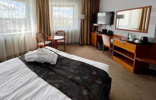 Postel nebo postele na pokoji v ubytování City Hotel