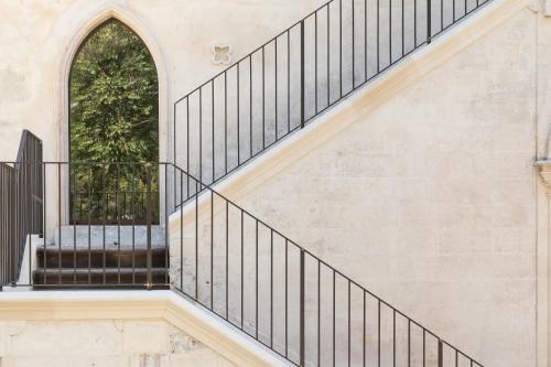 a staircase with black railings and a window at Villa Boscarino Boutique Hotel & Spa in Ragusa