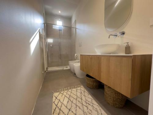 a bathroom with a sink and a shower and a toilet at Realkasa Charming Luxury Apt. in Bologna