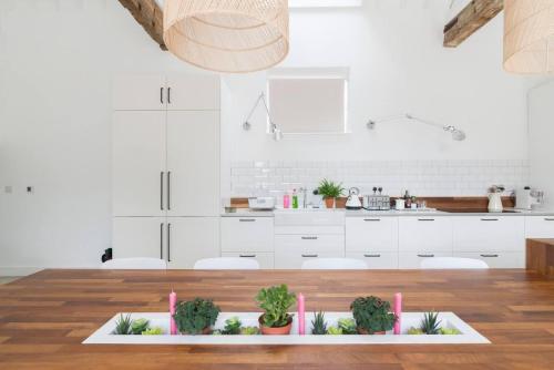 a kitchen with a table with potted plants on it at Simple Coastal Luxury near Southwold sleeps 10 in Southwold