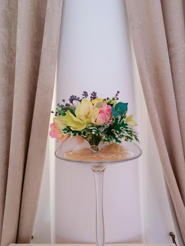 a bouquet of flowers sitting on a glass table at Hotel & Banquet Hall SV Airport Parkway in Todoreshty