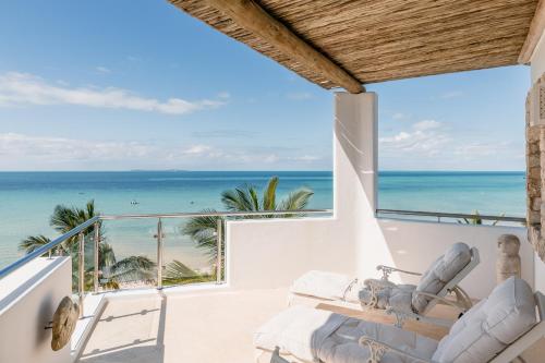 a bedroom with a view of the ocean at Villa Santorini in Vilanculos