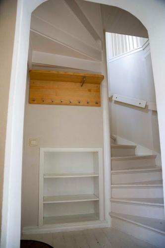 a staircase in a house with white shelves at Eksjö Stadshotell in Eksjö