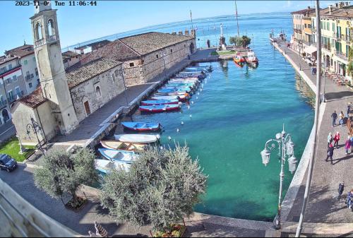 a group of boats are docked in a canal at Studio Centrale Pacengo di Lazise in Lazise
