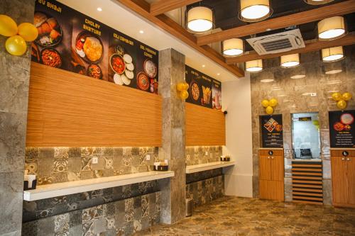 a fast food restaurant with a menu on the wall at Kalinga Hotel in Jodhpur