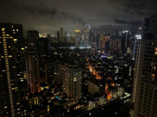a view of a city at night at Prime Posh Downtown Condo in Manila