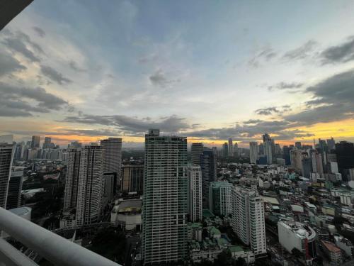 a view of a city at sunset with buildings at Prime Posh Downtown Condo in Manila