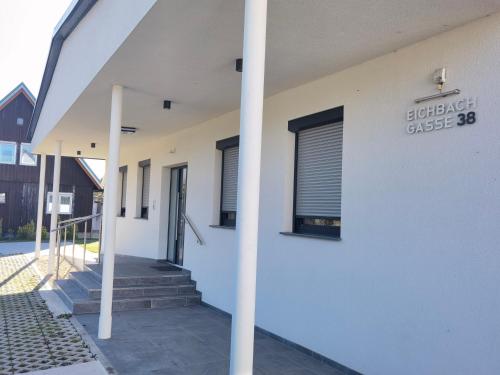 a white building with a sign on the side of it at Eichbachgasse 38 in Graz