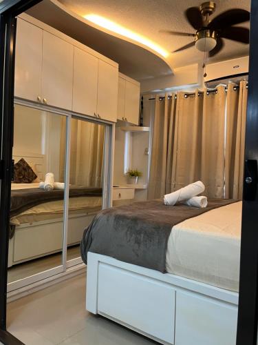 a bedroom with a large bed and a ceiling fan at Joling's Crib wid Netflix and strong wifi and with a small veranda and facing amenities in Davao City