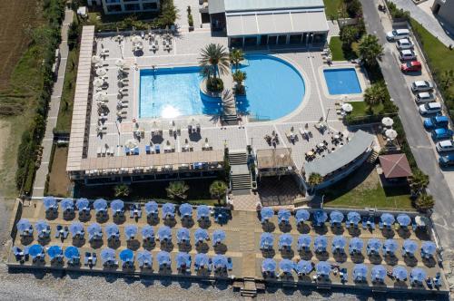 an overhead view of a pool with chairs and umbrellas at Hydramis Palace Beach Resort in Georgioupolis