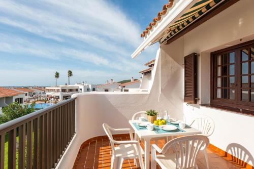 a patio with a table and chairs on a balcony at Apartamentos en Son Bou in Son Bou