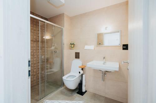 a bathroom with a toilet and a sink and a shower at Apartmán Collin X41 in Dolný Kubín