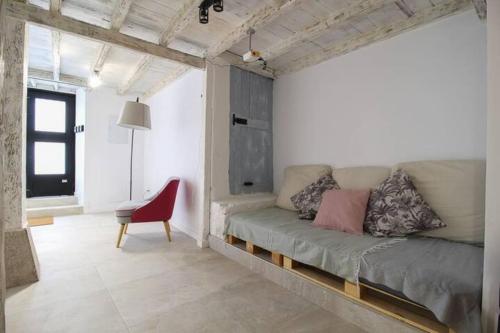 a living room with a couch and a red chair at Vivienda en el Centro de Santander in Santander