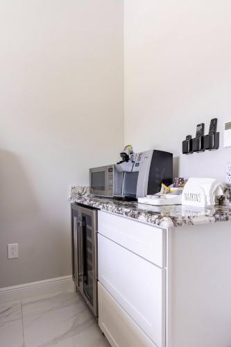 a kitchen with a counter top with a microwave at Voyager Inn in Merritt Island