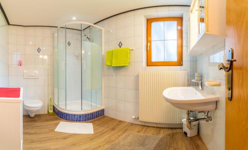 a bathroom with a shower toilet and a sink at Landhaus Toni in Neustift im Stubaital