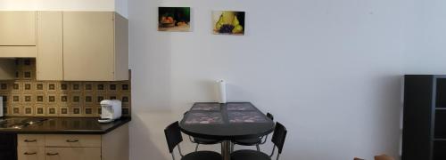 a small kitchen with a table in the corner at Aparta hotel DAJAS in Lausanne