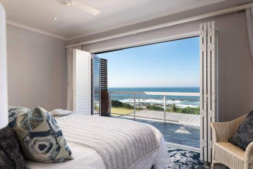 a bedroom with a bed and a view of the ocean at Cockleshell in Westbrook