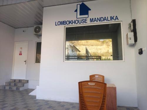 a sign for the london house mandalaalauseum on a wall at Lombokhouse Mandalika in Kuta Lombok