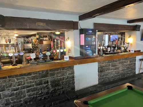 a bar with a pool table in front of it at The White Lion Hotel in Bridgend
