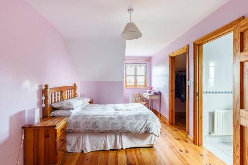 a bedroom with a bed and a wooden floor at Yellow House in Westport