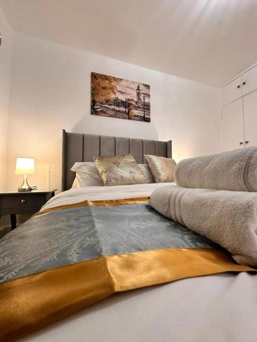 a bedroom with a large bed with a large headboard at Luxury London apartment in prime location in London