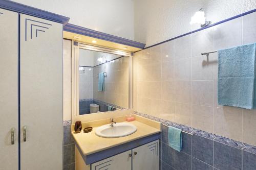 a bathroom with a sink and a mirror at Apartment Hibiscus in Grand-Baie