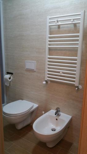 a bathroom with a white toilet and a sink at Hotel Tommaseo in Genoa