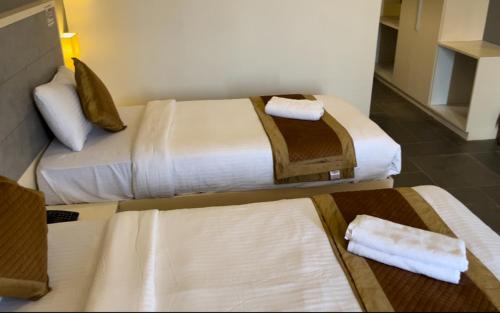 Ein Bett oder Betten in einem Zimmer der Unterkunft Hotel Dwarawata