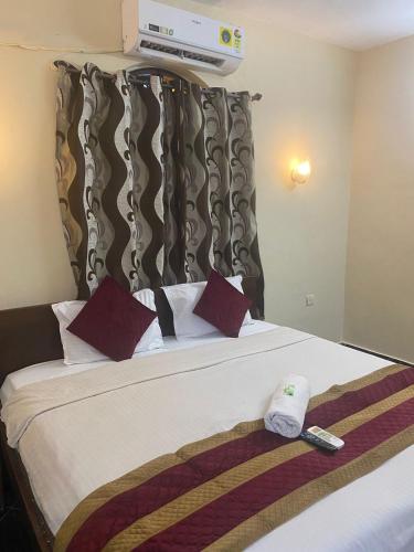 a hotel room with a bed with two towels on it at Baga Beach Crystal in Baga