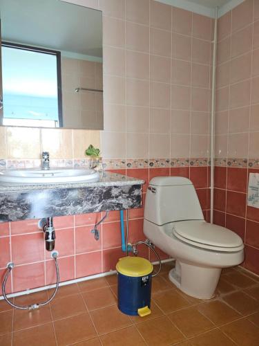 a bathroom with a toilet and a sink and a tub at Lanta MP Place in Ko Lanta