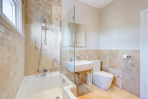 a bathroom with a tub and a sink and a toilet at Pass the Keys Large house Leigh Sea views in Southend-on-Sea