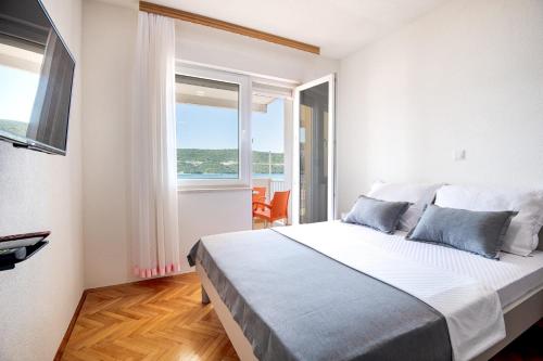 Postel nebo postele na pokoji v ubytování Apartmani Sunce