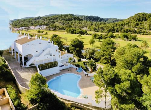 an aerial view of a resort with a swimming pool at Peaceful Flat Menorca Sea And Wifi in Son Parc