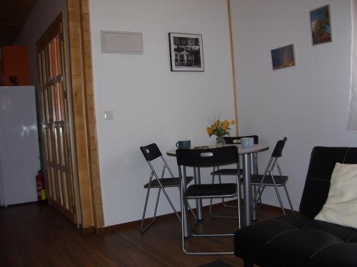 a room with a table and chairs and a couch at Vivienda de uso turístico Fuente Vilda VT-LR 0033 in Alcanadre