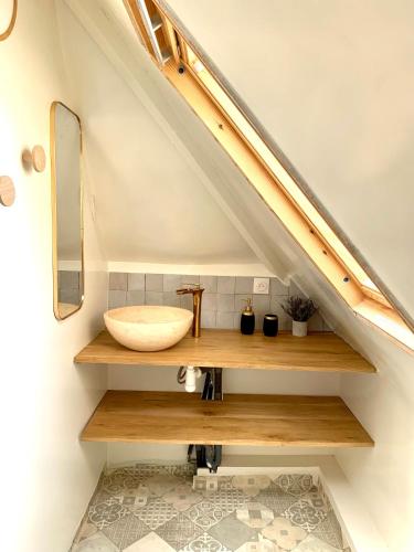 a bathroom with a sink under the stairs at Charmante maison Cabourg in Cabourg