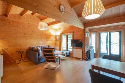 a living room with a couch and a table at Chalet Zandvoort - Free Parking in Zandvoort