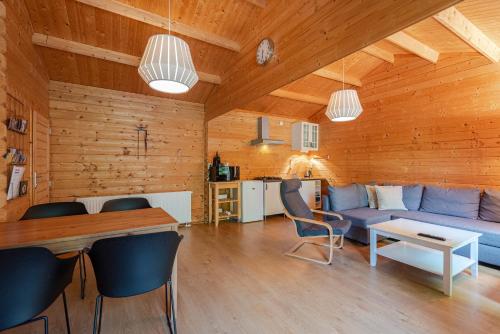 a living room with a blue couch and a table at Chalet Zandvoort - Free Parking in Zandvoort