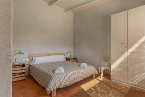 a bedroom with a bed and a dresser in it at Casa de campo Masos de Pals con parking y piscina in Pals