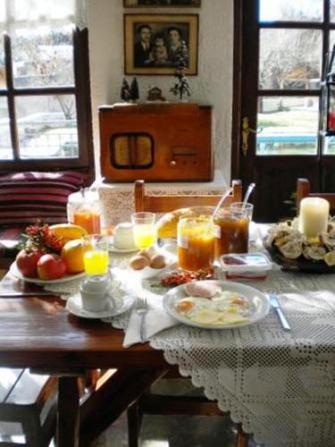 a table with breakfast foods and drinks on it at Agrampeli in Méga Khoríon