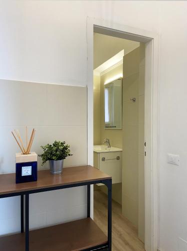 a bathroom with a table with a plant on it at Residence Intur in Marciana Marina