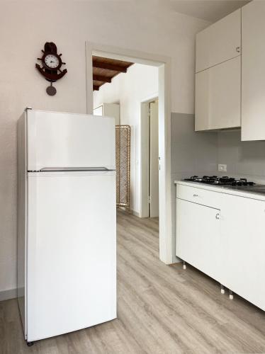 a kitchen with a white refrigerator in a room at Residence Intur in Marciana Marina